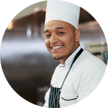 Man in chef's hat and black apron